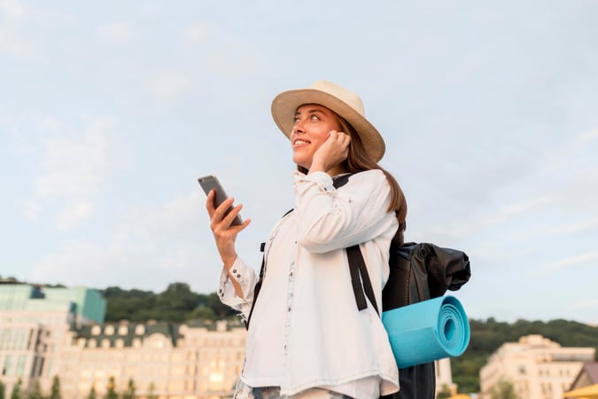 side-view-woman-with-backpack-smartphone-traveling